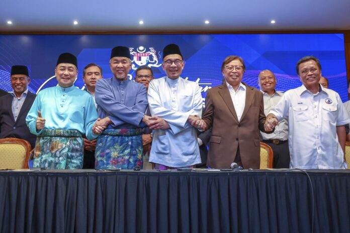 Group of Malaysian politicians in parliament discussing a bill