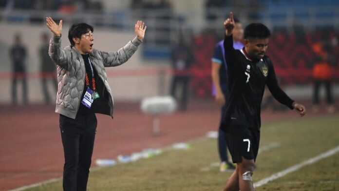Coach Shin Tae-yong of the Indonesian national team looks on as a player is fouled during a 2022 AFF Championship match.
