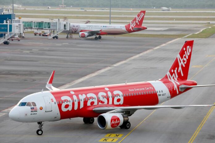 Red AirAsia Plane, AirAsia Suspends Kuching to Penang Flights effective March 1 malaysia latest news kuching news malaysianews.my