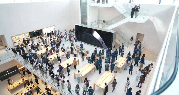 Grand opening of Apple Store Malaysia at The Exchange TRX, showcasing a large crowd of visitors exploring the sleek and modern retail space.