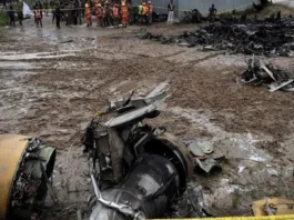 Wreckage of Saurya Airlines plane crash at Tribhuvan International Airport, Kathmandu, covered by rescue workers, highlighting a tragic event in Nepal aviation history, covered by Malaysia news. malaysianews.my