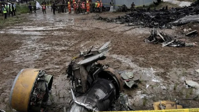 Wreckage of Saurya Airlines plane crash at Tribhuvan International Airport, Kathmandu, covered by rescue workers, highlighting a tragic event in Nepal aviation history, covered by Malaysia news. malaysianews.my