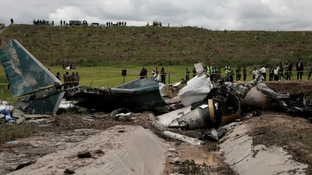 The wreckage of the Saurya Airlines plane crash at Tribhuvan International Airport, Kathmandu, with emergency personnel on site, covered by Malaysia news.